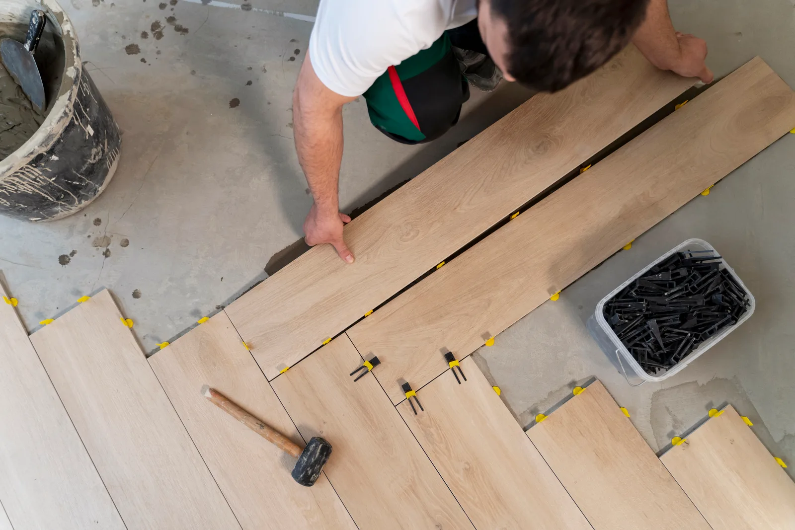 Tradesperson laying floor tiles